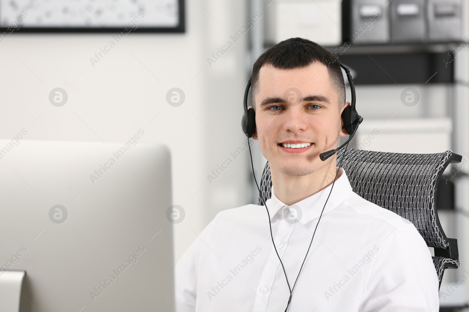 Photo of Hotline operator with headset working in office