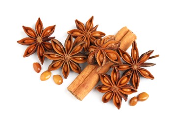 Photo of Dry anise stars and cinnamon stick on white background, top view