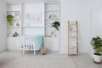 Photo of Bedroom interior with stylish crib for newborn baby