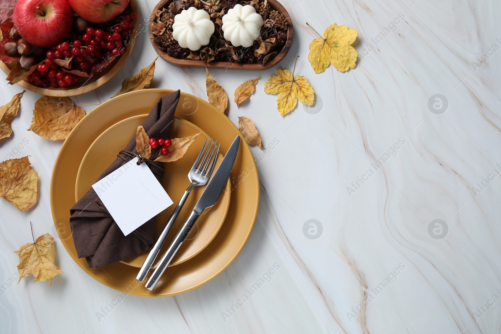 Photo of Happy Thanksgiving day. Beautiful table setting with autumn decor and empty card, flat lay. Space for text