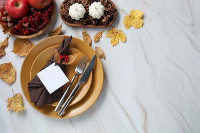 Photo of Happy Thanksgiving day. Beautiful table setting with autumn decor and empty card, flat lay. Space for text