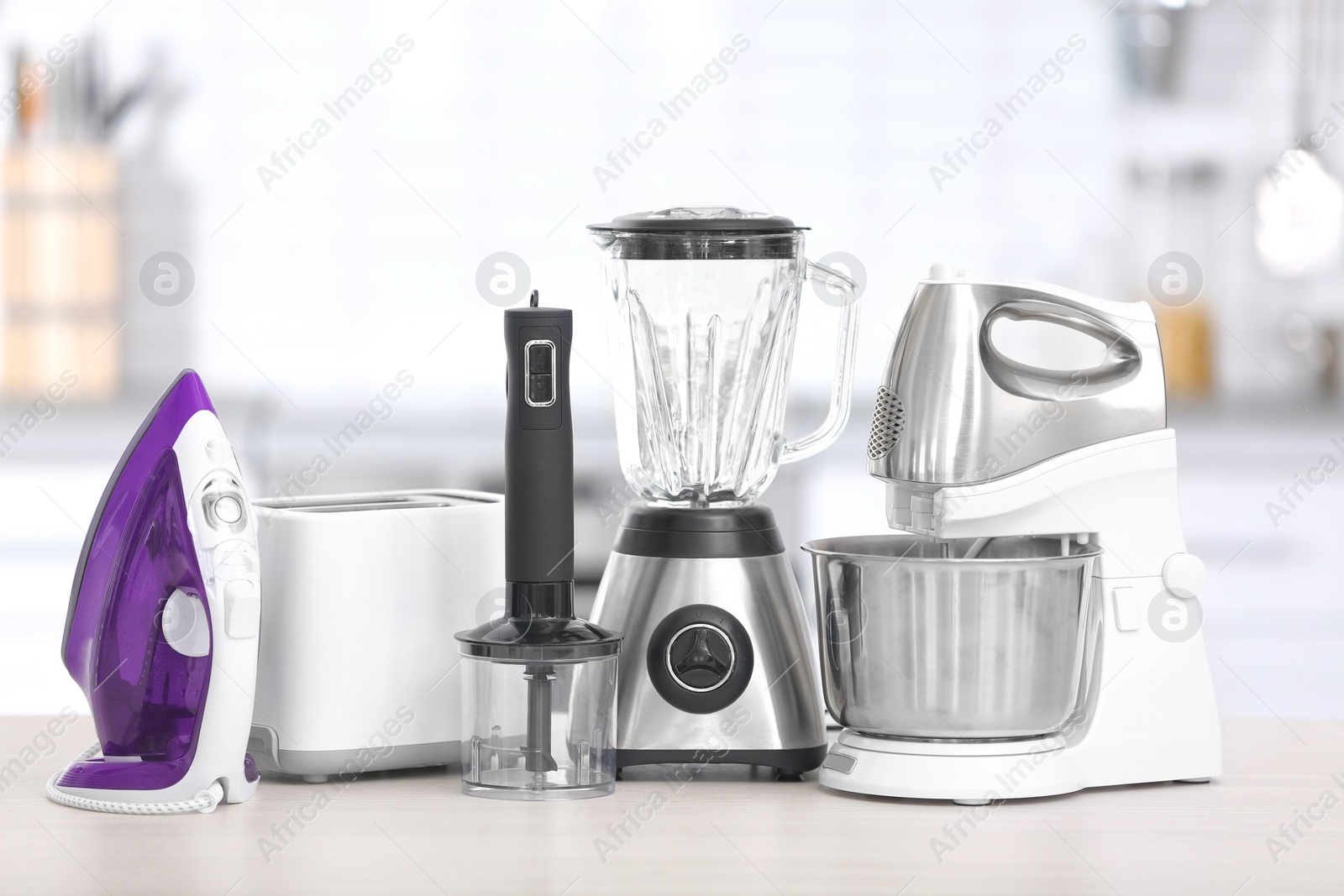 Photo of Household and kitchen appliances on table indoors. Interior element