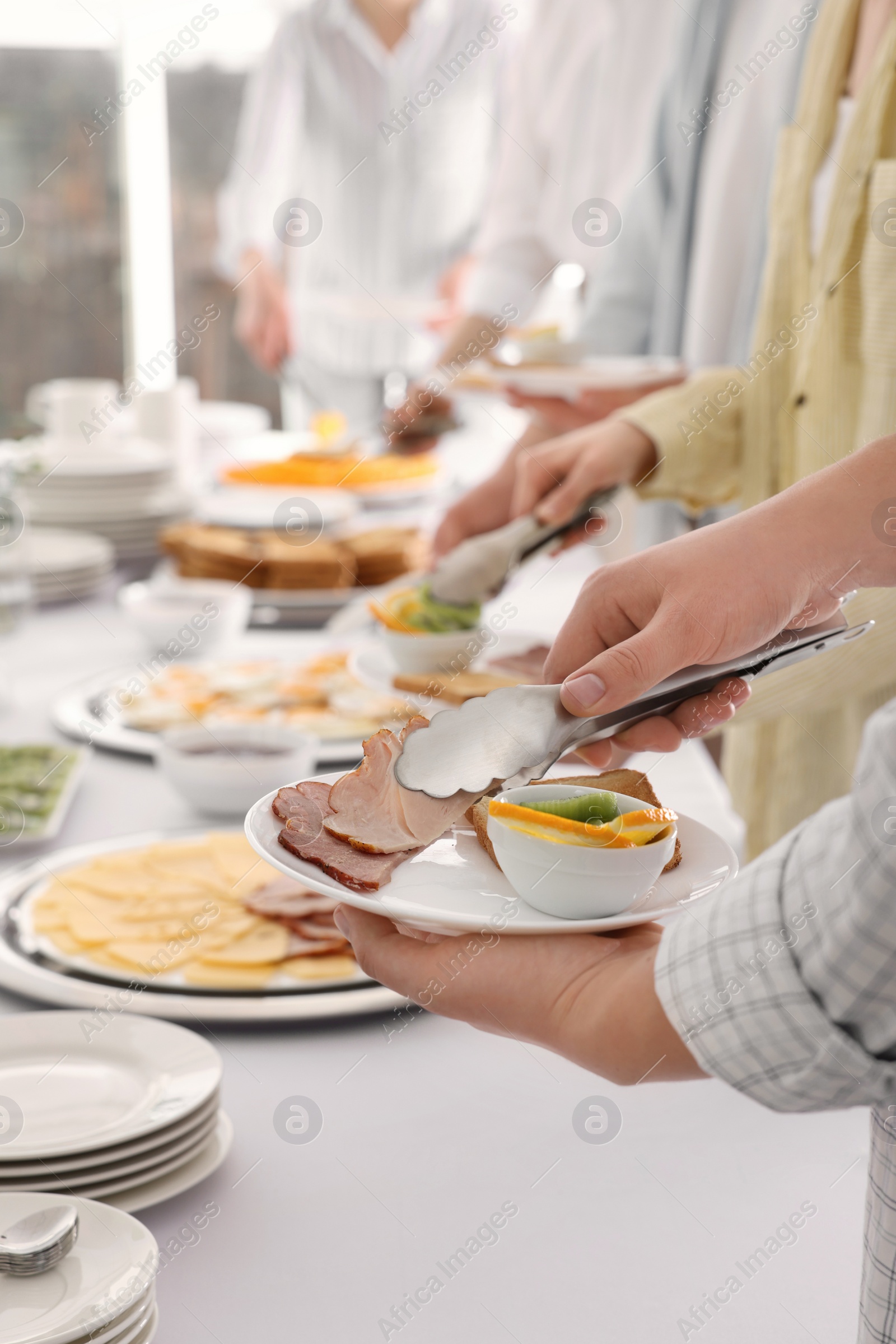 Photo of People taking food during breakfast, closeup. Buffet service