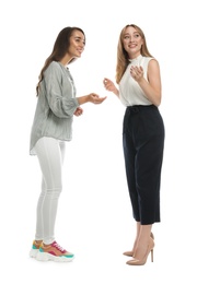 Photo of Young women in casual clothes talking on white background