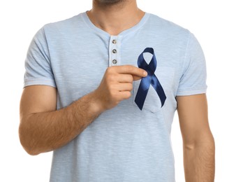 Man with blue ribbon on white background, closeup. Urology cancer awareness