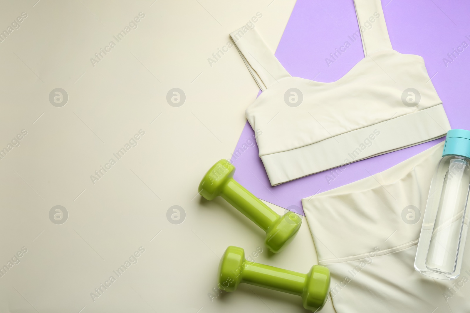 Photo of Flat lay composition with sportswear and equipment on color background, space for text. Gym workout