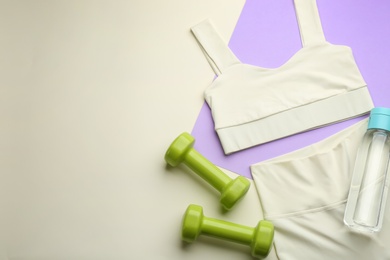 Photo of Flat lay composition with sportswear and equipment on color background, space for text. Gym workout