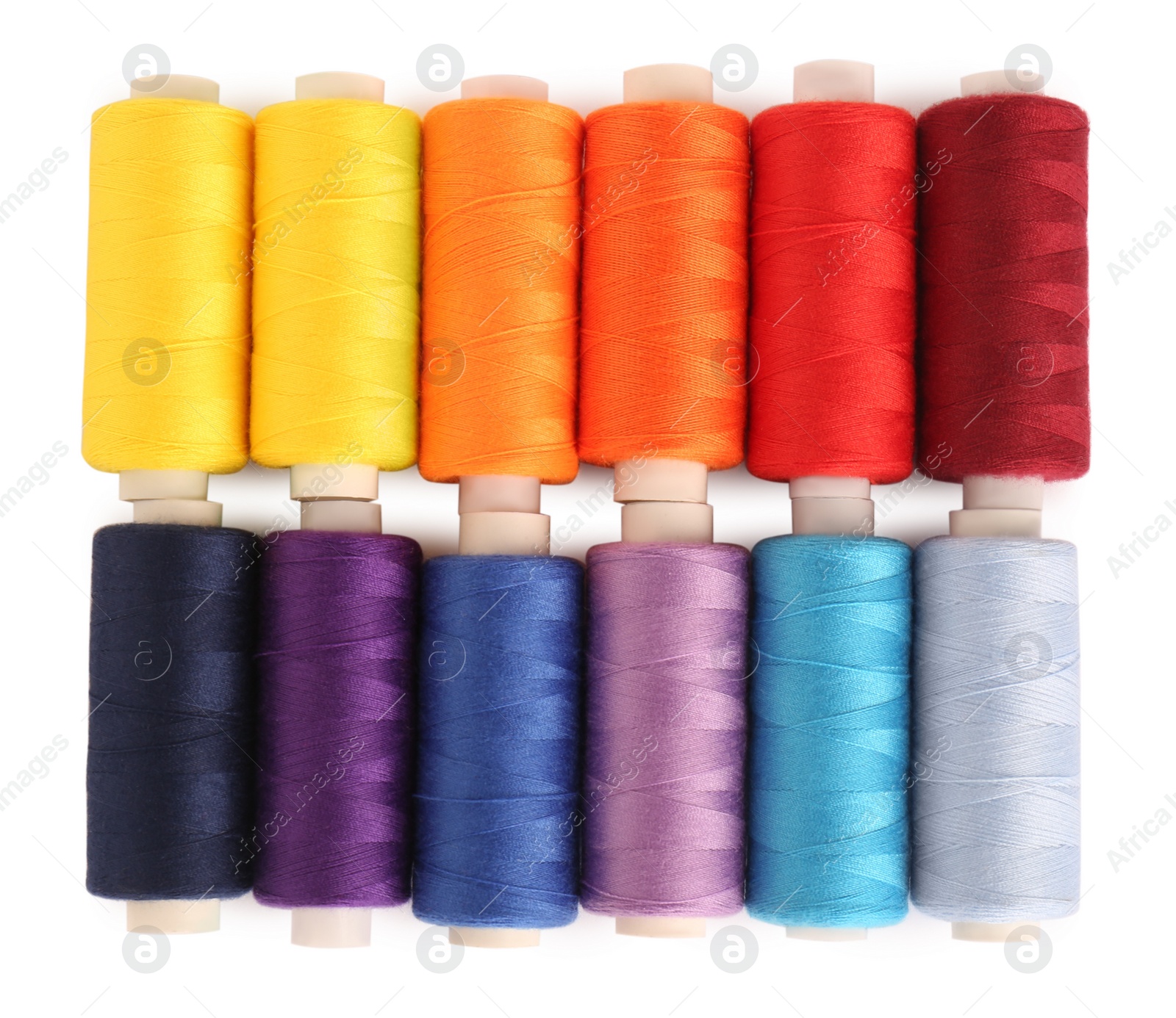 Photo of Set of colorful sewing threads on white background, top view