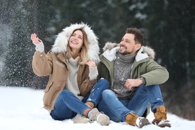 Couple spending time outdoors on snowy day. Winter vacation