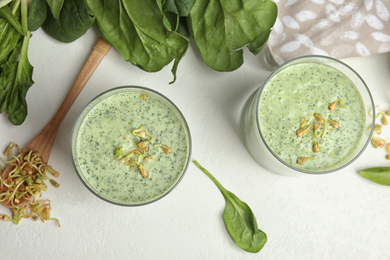 Flat lay composition with green buckwheat smoothie 
on white table