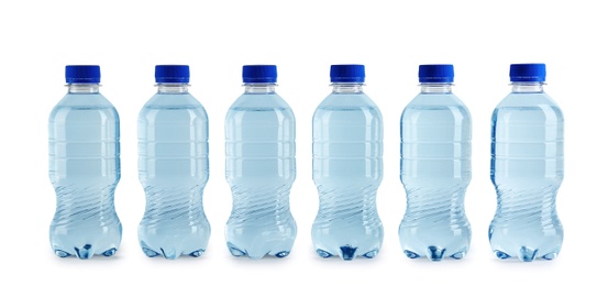 Photo of Collection of plastic bottles with water on white background