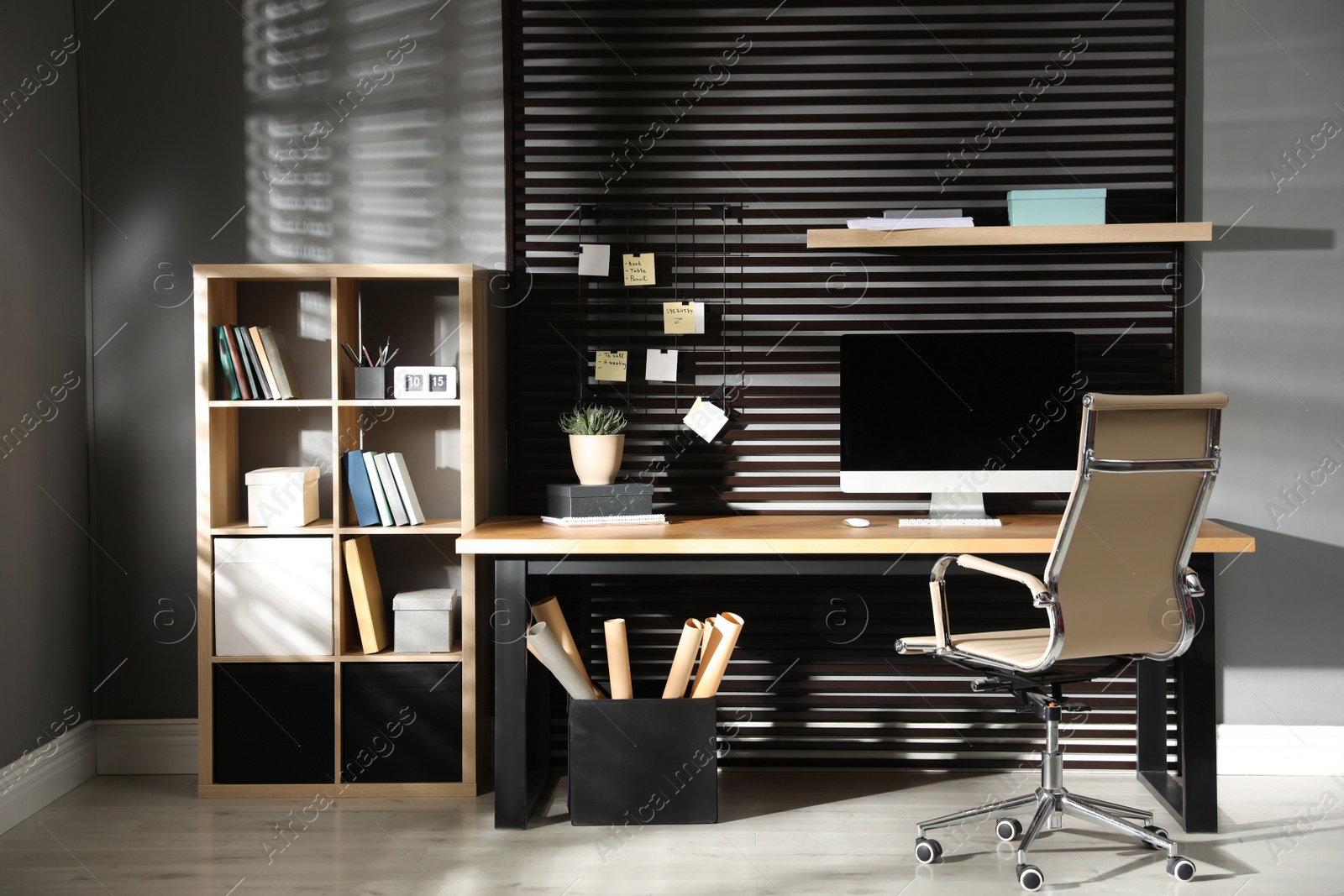 Photo of Comfortable workplace with computer and office chair. Stylish room interior