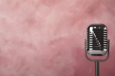 Photo of Retro microphone on color background. Space for text