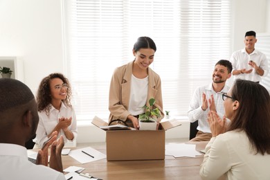 Photo of Group of coworkers welcoming new employee in team indoors