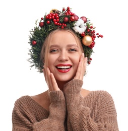 Beautiful young woman wearing Christmas wreath on white background