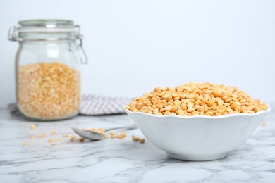 Photo of Ceramic bowl with dried peas on table