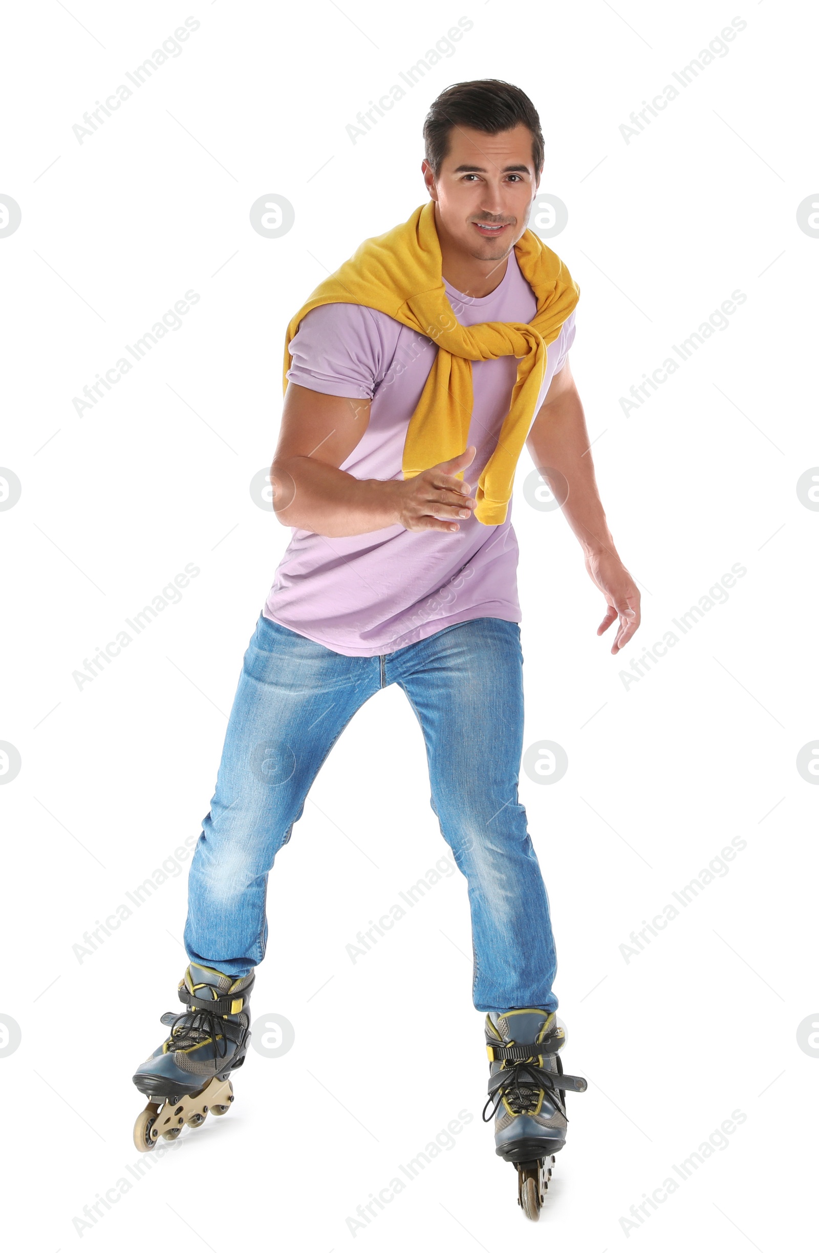 Photo of Handsome young man with inline roller skates on white background