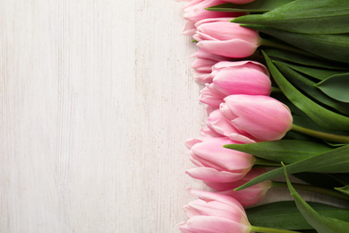 Photo of Beautiful pink spring tulips on white wooden background, flat lay. Space for text