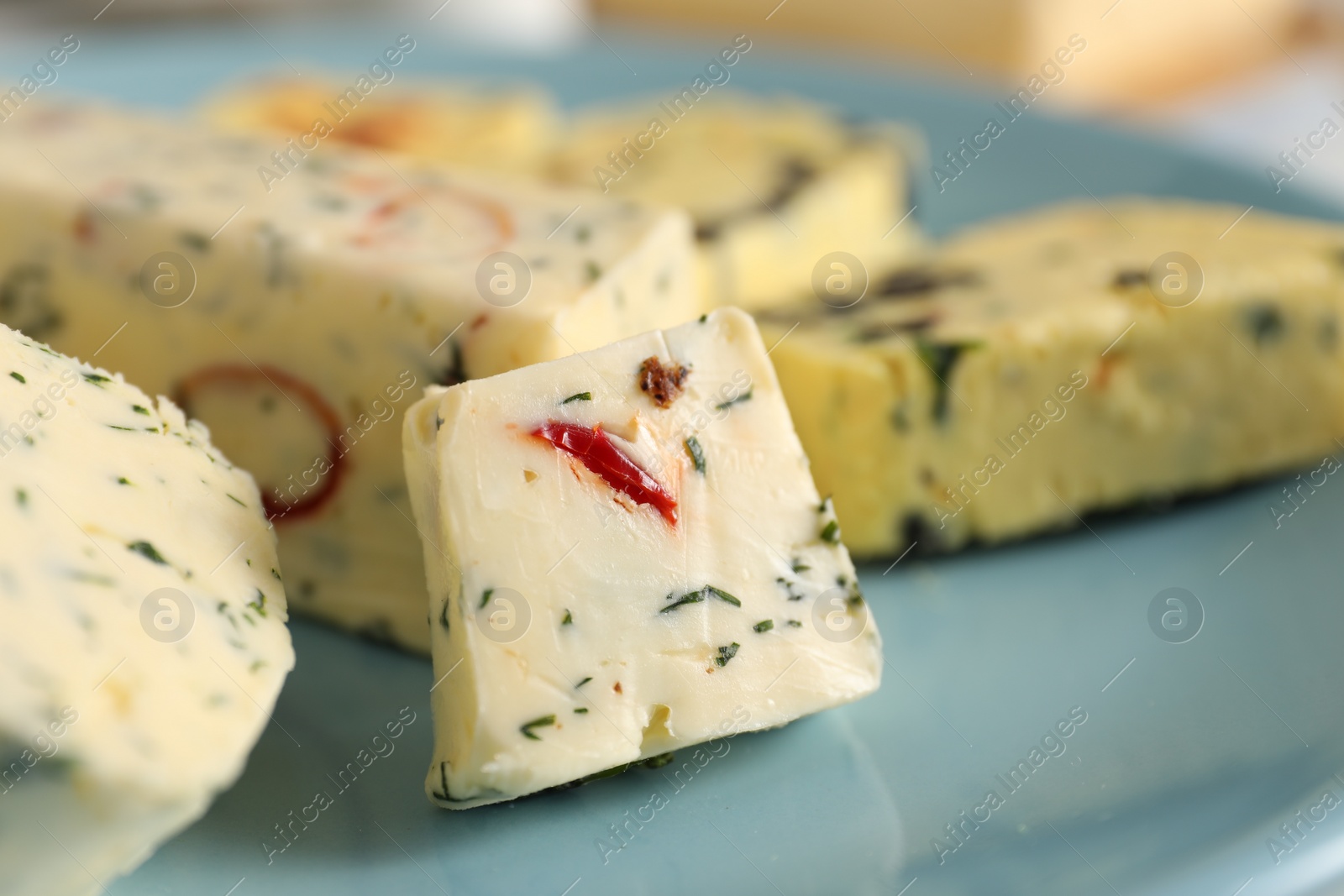 Photo of Tasty butter with herbs and spices on plate, closeup