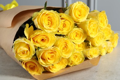 Beautiful bouquet of yellow roses on light grey table, closeup
