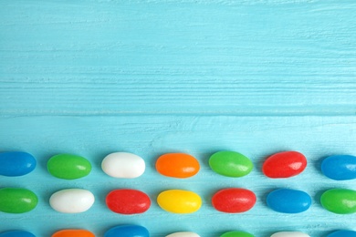 Flat lay composition with jelly beans on color background. Space for text