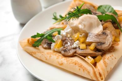 Photo of Delicious breakfast with thin pancakes on plate, closeup