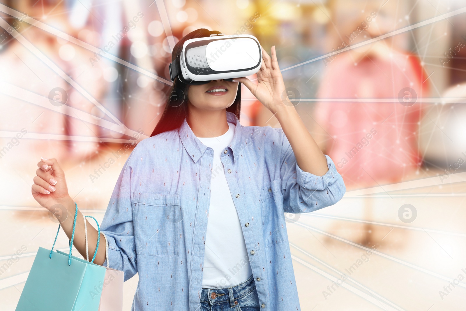 Image of Young woman with shopping bags using virtual reality headset in simulated store