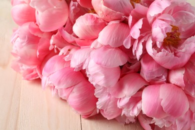 Photo of Beautiful pink peonies on wooden table, closeup