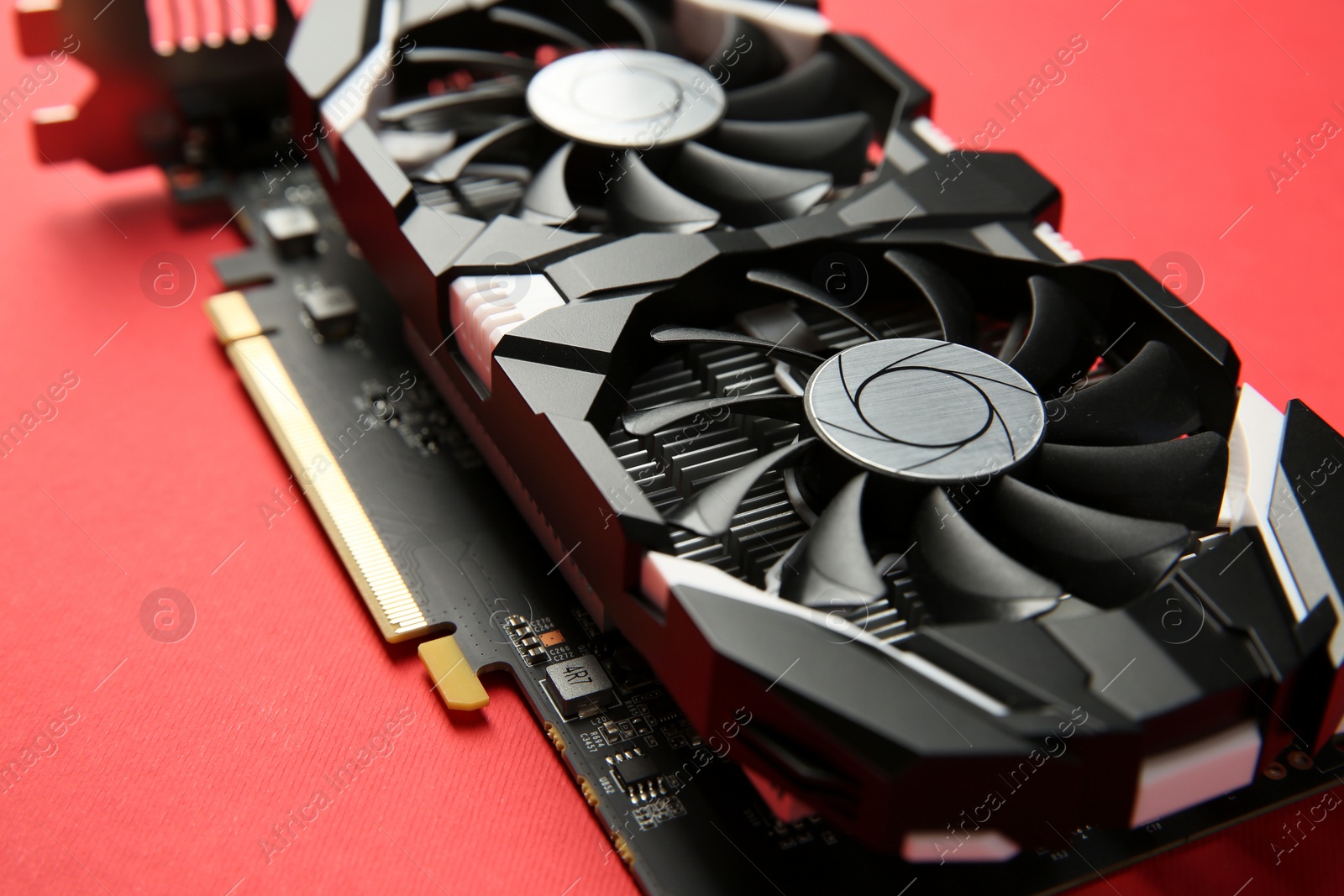 Photo of Computer graphics card on red background, closeup