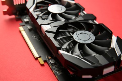 Photo of Computer graphics card on red background, closeup