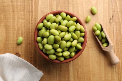Organic edamame beans on wooden table, flat lay