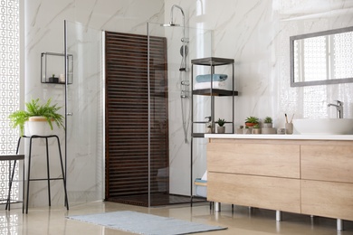 Photo of Bathroom interior with shower stall, counter and houseplants. Idea for design