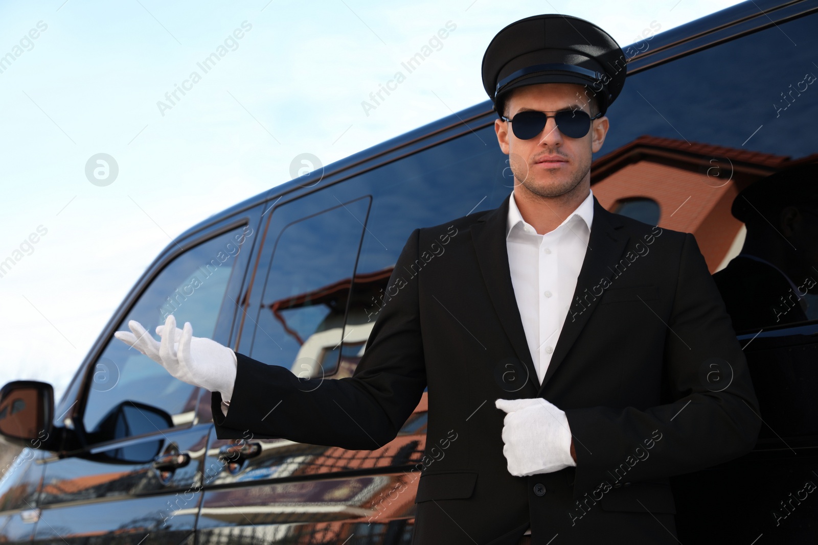 Photo of Professional driver near luxury car. Chauffeur service