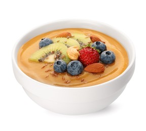 Delicious smoothie bowl with fresh berries, kiwi and nuts on white background