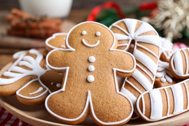 Photo of Delicious gingerbread Christmas cookies on plate, closeup