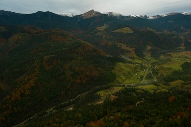 Image of Aerial view of beautiful mountain village on cloudy day