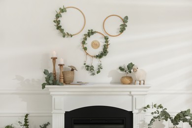 Stylish room with beautiful fireplace and eucalyptus branches