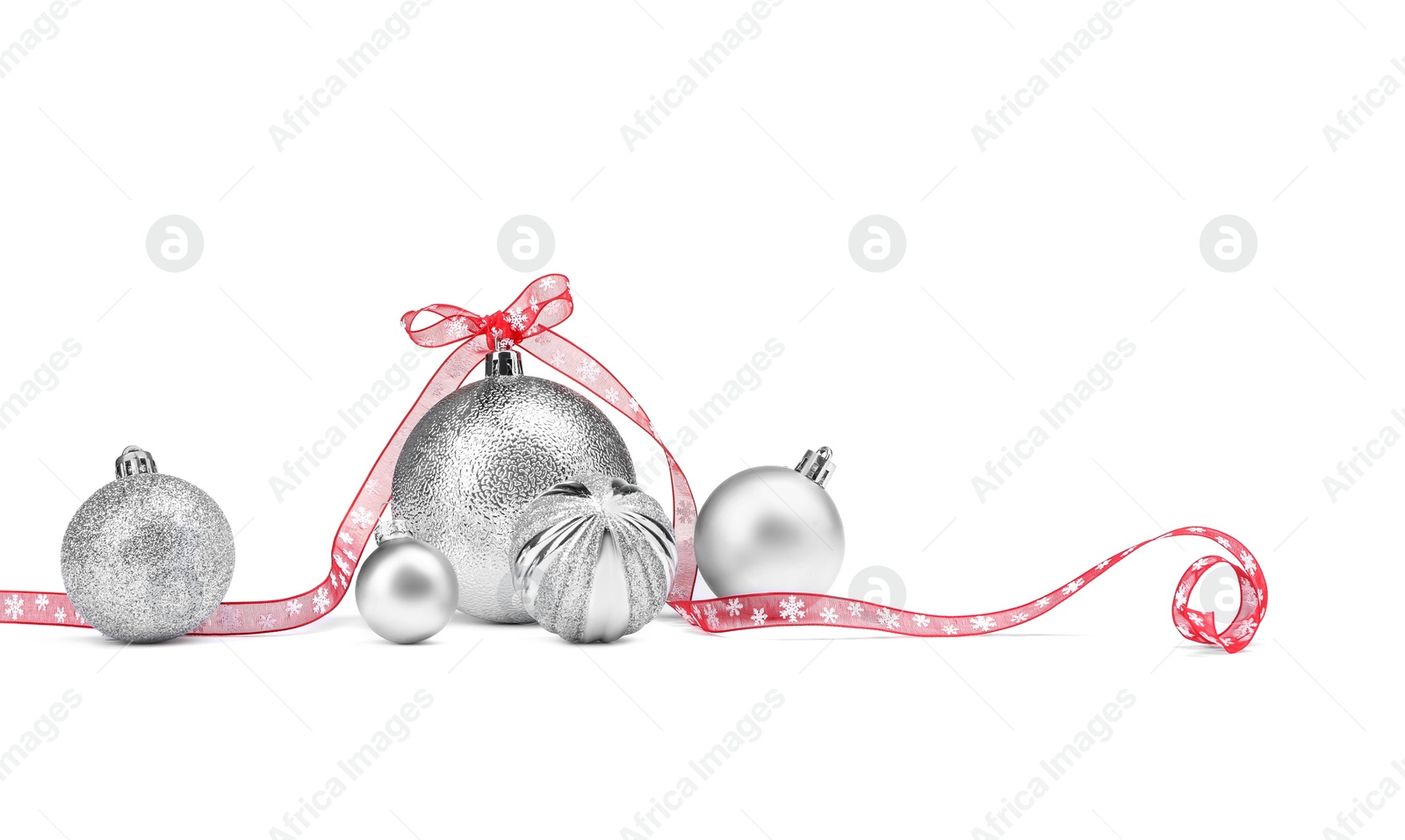 Photo of Beautiful Christmas balls and red ribbon isolated on white