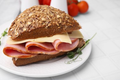Photo of Delicious sandwich with ham and cheese on white table, closeup
