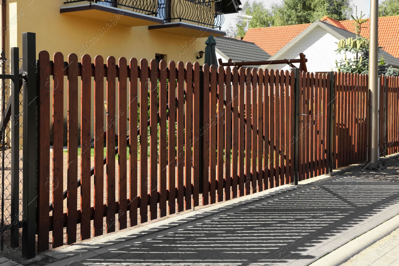 Photo of Closed wooden gates near beautiful houses outdoors
