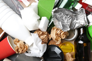 Photo of Pile of different garbage as background, top view. Recycling problem