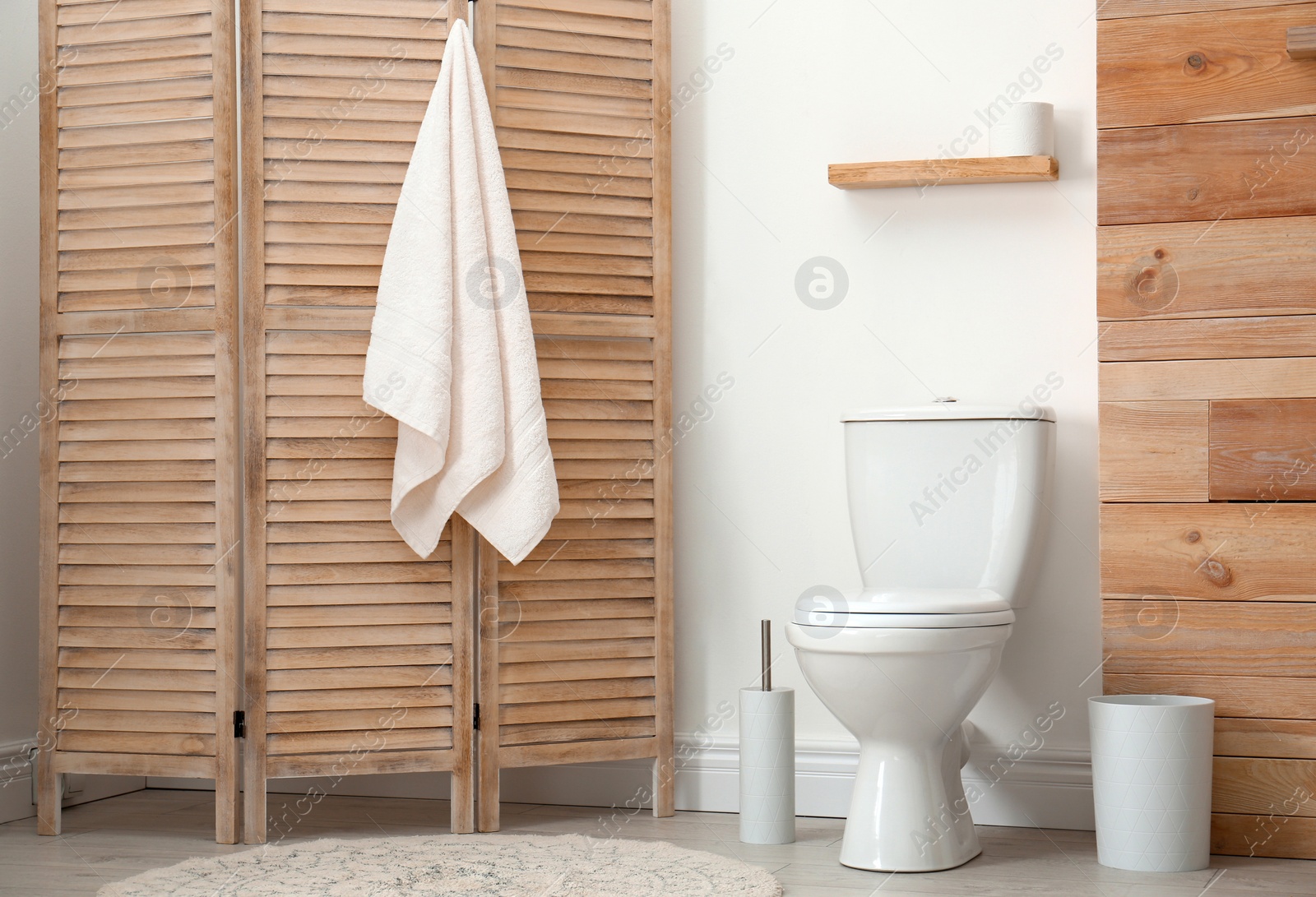 Photo of Toilet bowl near white wall in modern bathroom interior