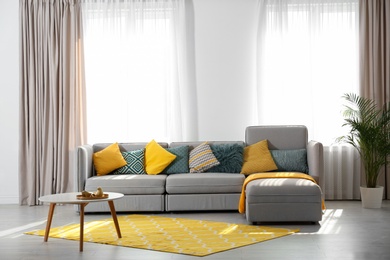 Stylish living room interior with comfortable sofa. Space for text