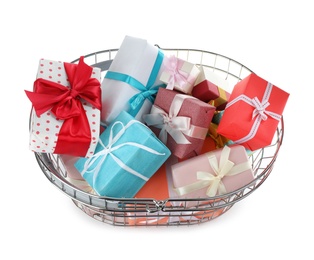 Photo of Shopping basket full of gift boxes on white background