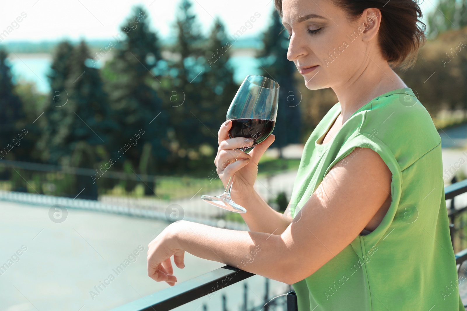 Photo of Woman with glass of red wine outdoors