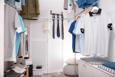 Modern dressing room with different stylish clothes and accessories