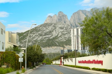 Mexico, San Pedro Garza Garcia - August 27, 2022: City street near beautiful mountains