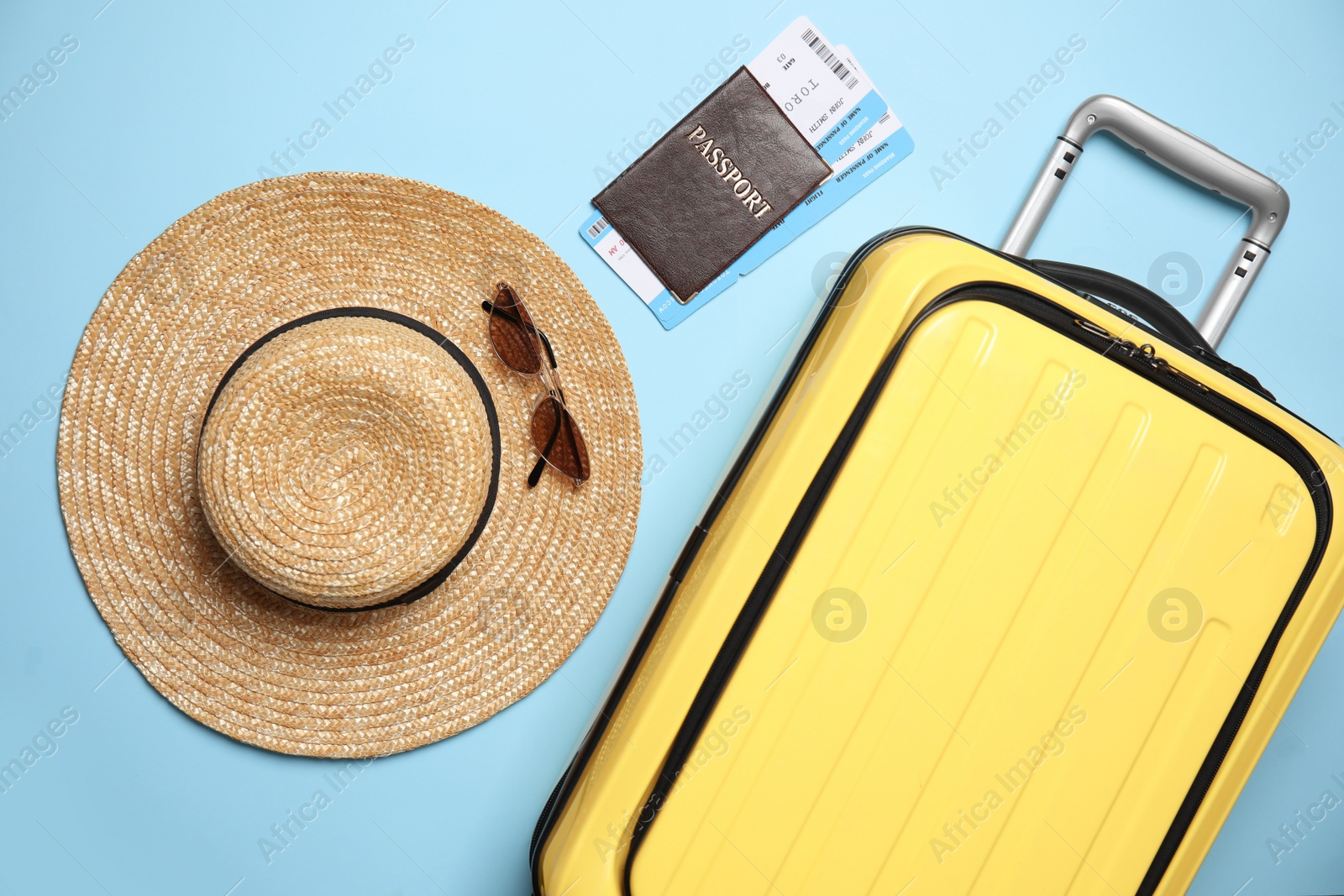 Photo of Flat lay composition with passport, tickets and travel items on light blue background