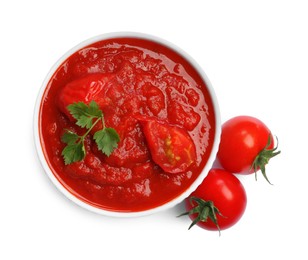 Photo of Homemade tomato sauce in bowl and fresh ingredients isolated on white, top view