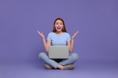 Photo of Happy young woman with laptop on lilac background